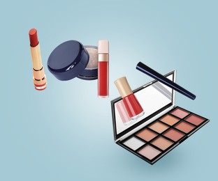 Image of Different makeup cosmetics in air against light blue background