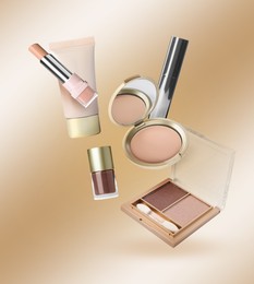 Image of Different makeup cosmetics in air against beige gradient background