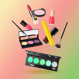 Image of Different makeup products in air against color gradient background