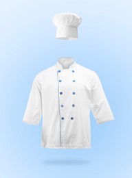 Image of Chef's uniform in air against light blue background. Toque and jacket