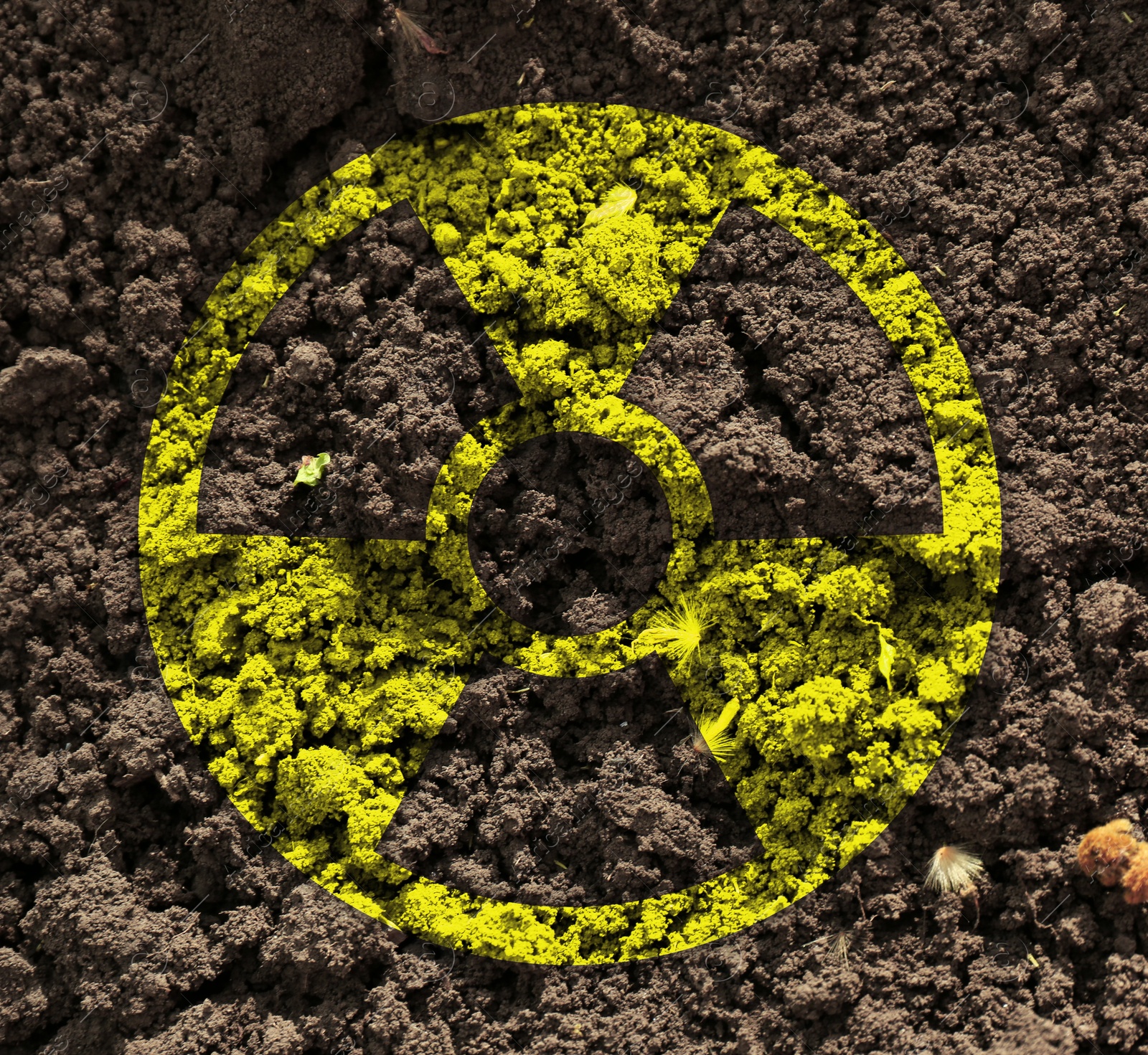 Image of Yellow radioactive sign on soil, top view. Radiological pollution