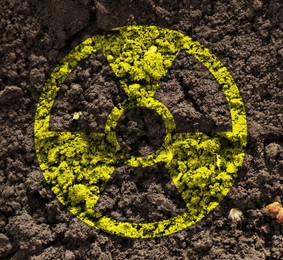 Image of Yellow radioactive sign on soil, top view. Radiological pollution