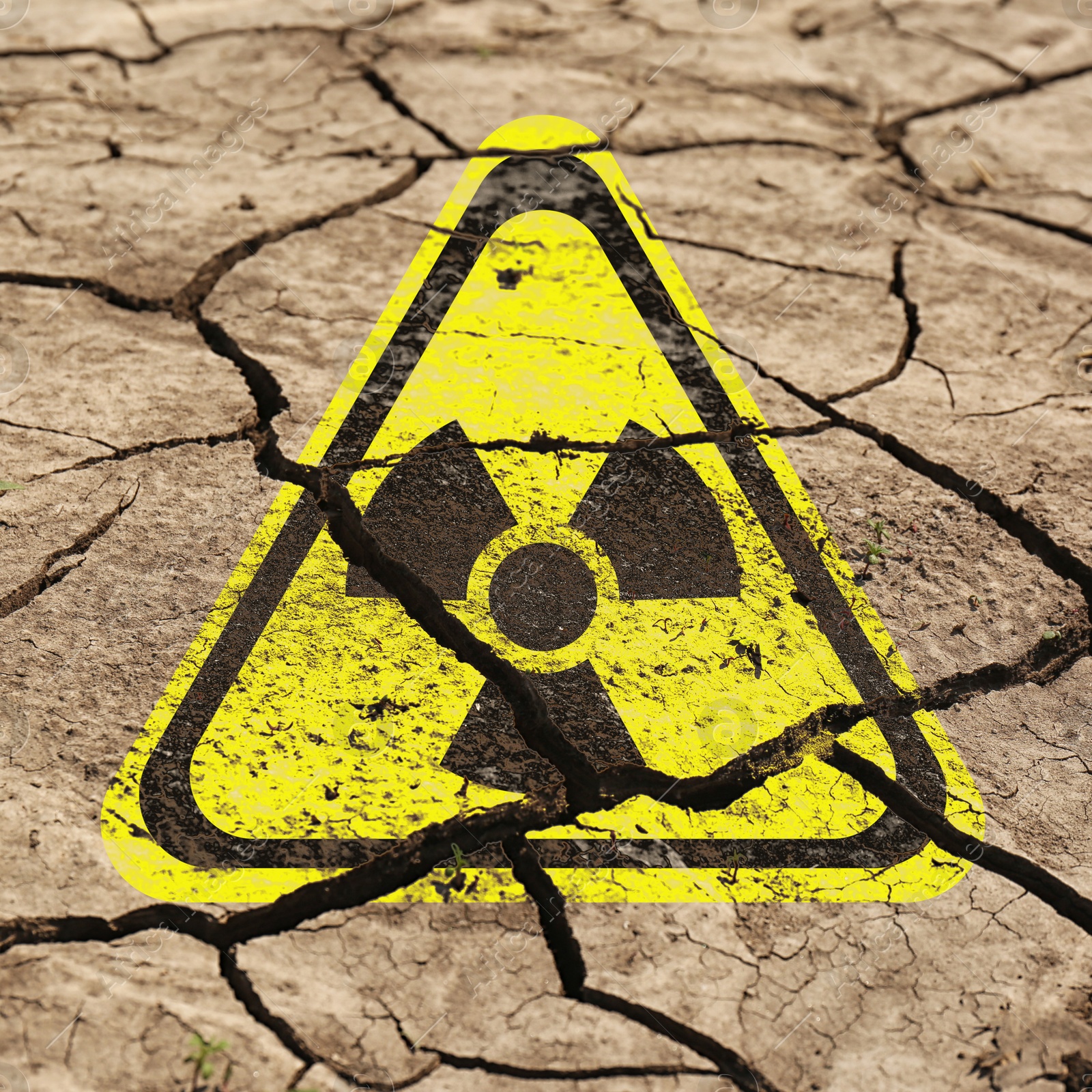 Yellow radioactive sign on cracked dry earth, closeup. Radiological pollution Image of Yellow radioactive sign on cracked dry earth, closeup. Radiological pollution