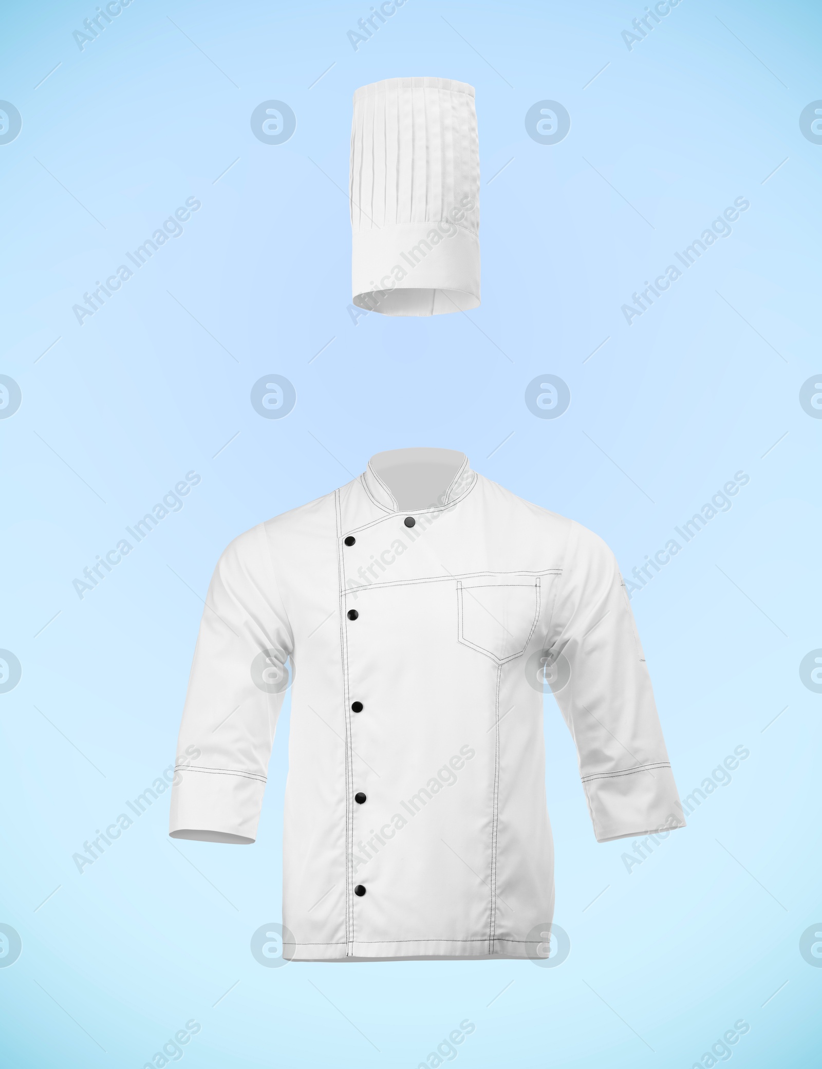Image of Chef's uniform in air against light blue background. Toque and jacket