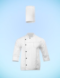 Image of Chef's uniform in air against light blue background. Toque and jacket