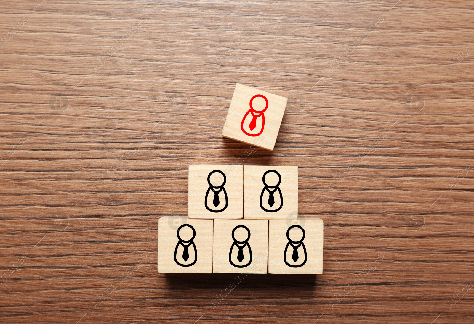 Dismissal. Cube with red human icon among others with black ones on wooden background, top view Image of Dismissal. Cube with red human icon among others with black ones on wooden background, top view