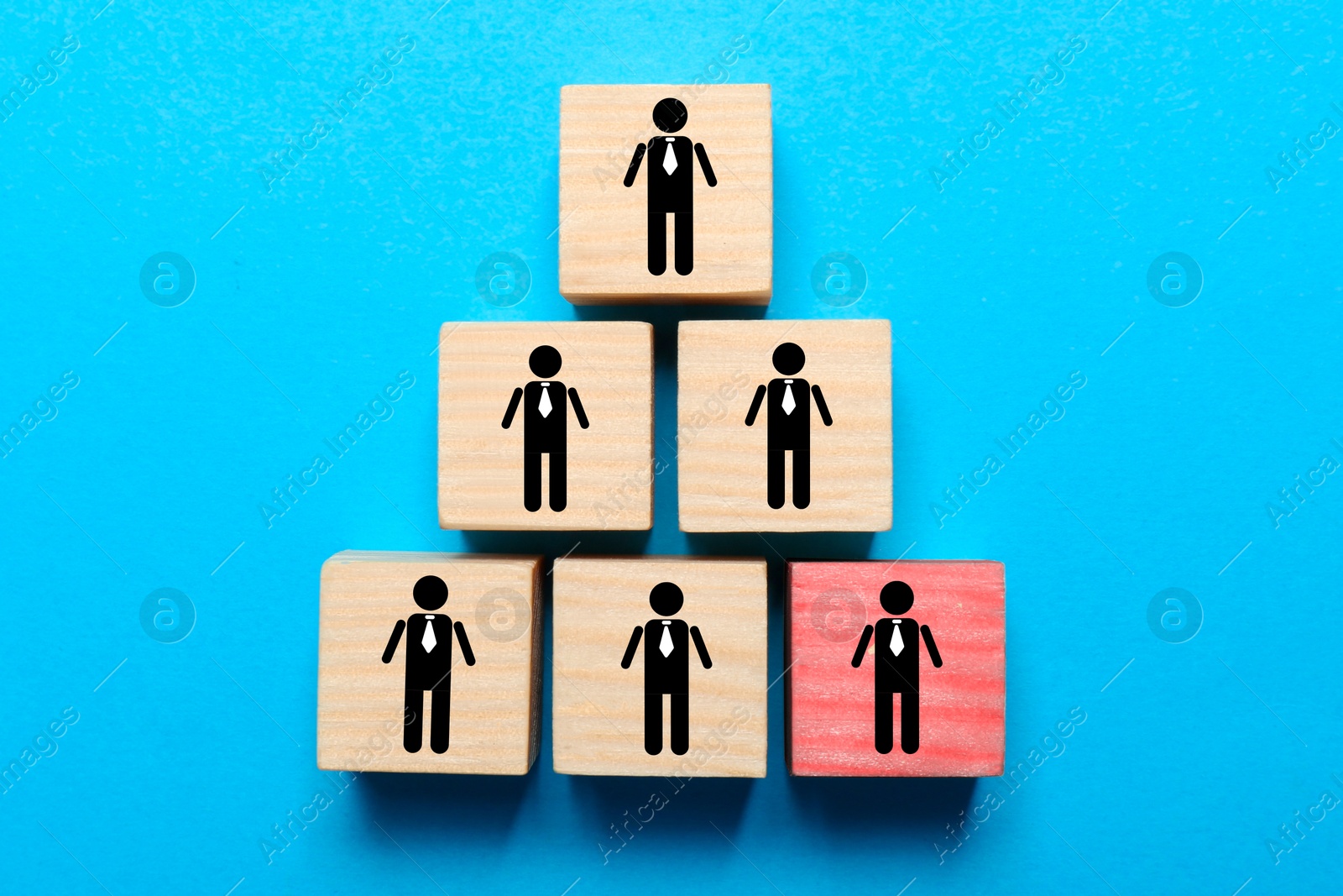 Dismissal. Cubes with human icons and one red on light blue background, top view Image of Dismissal. Cubes with human icons and one red on light blue background, top view