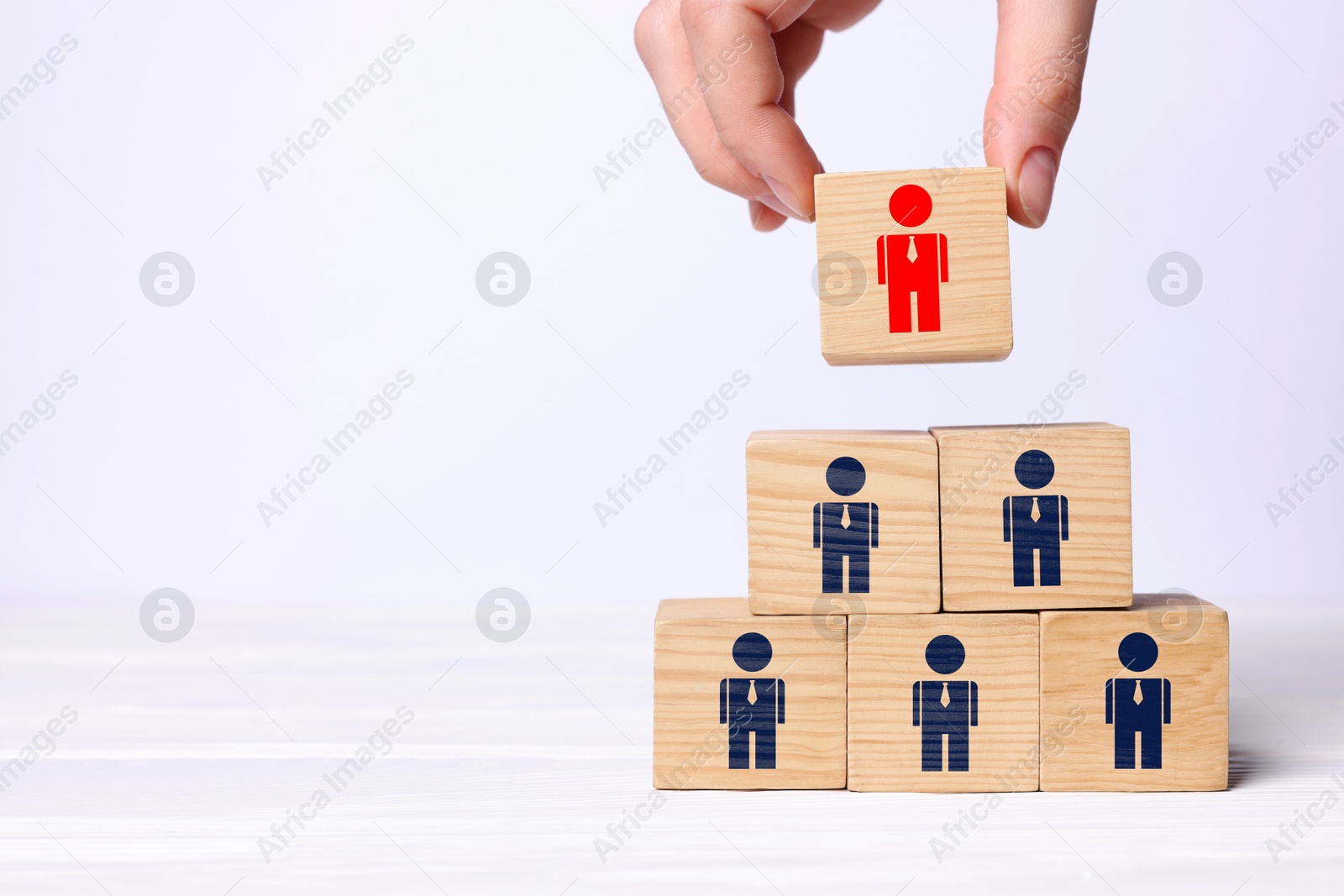 Dismissal. Woman taking cube with red human icon among others with blue ones on white background, closeup Image of Dismissal. Woman taking cube with red human icon among others with blue ones on white background, closeup