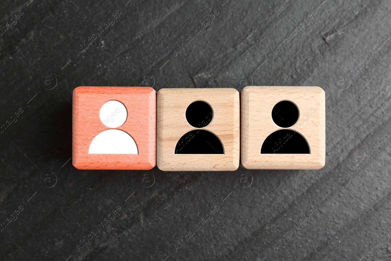Dismissal. Red cube with white human icon among others with black ones on grey textured background, top view Image of Dismissal. Red cube with white human icon among others with black ones on grey textured background, top view