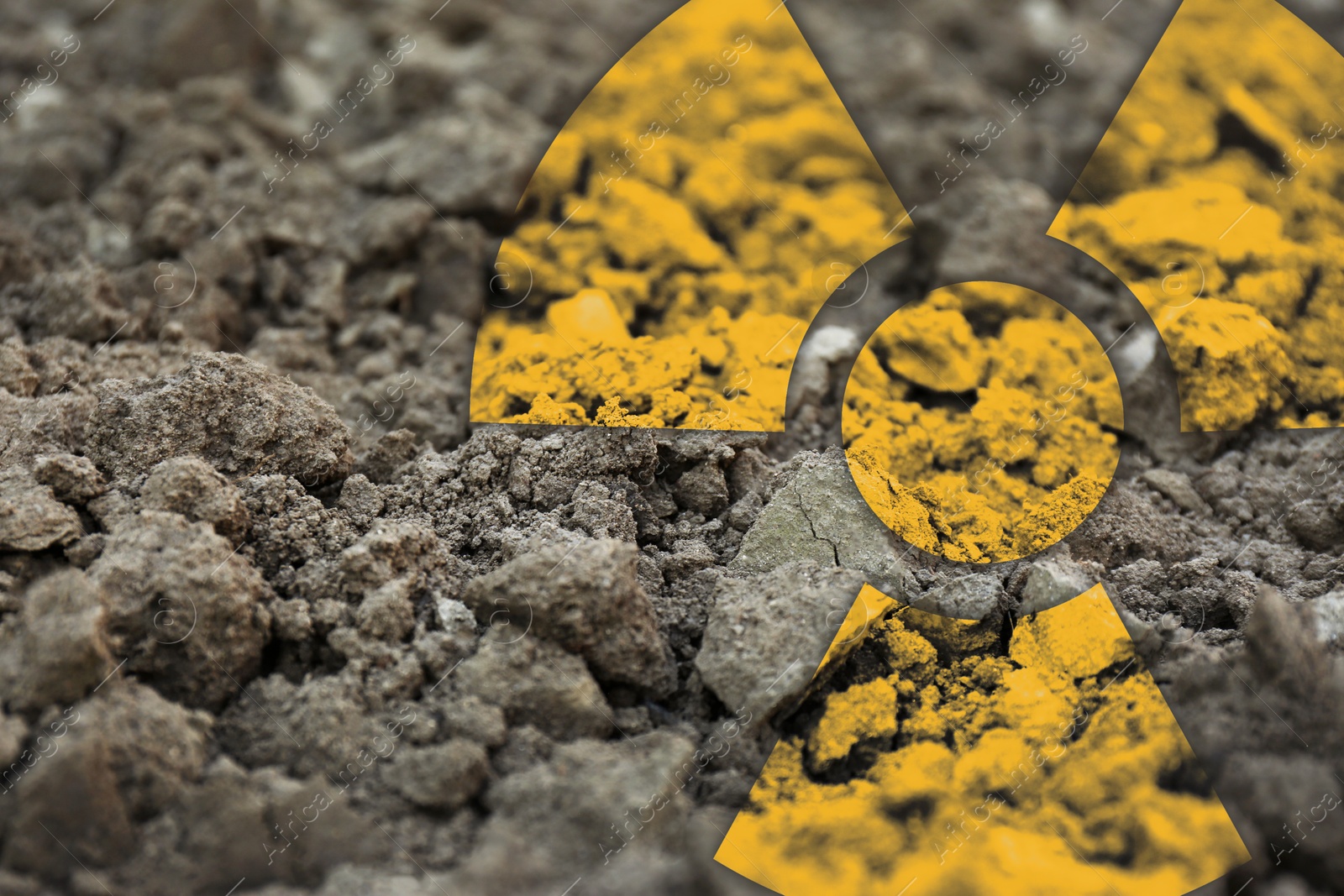 Image of Orange radioactive sign on soil, closeup view. Radiological pollution