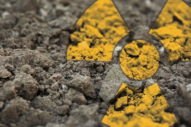Image of Orange radioactive sign on soil, closeup view. Radiological pollution