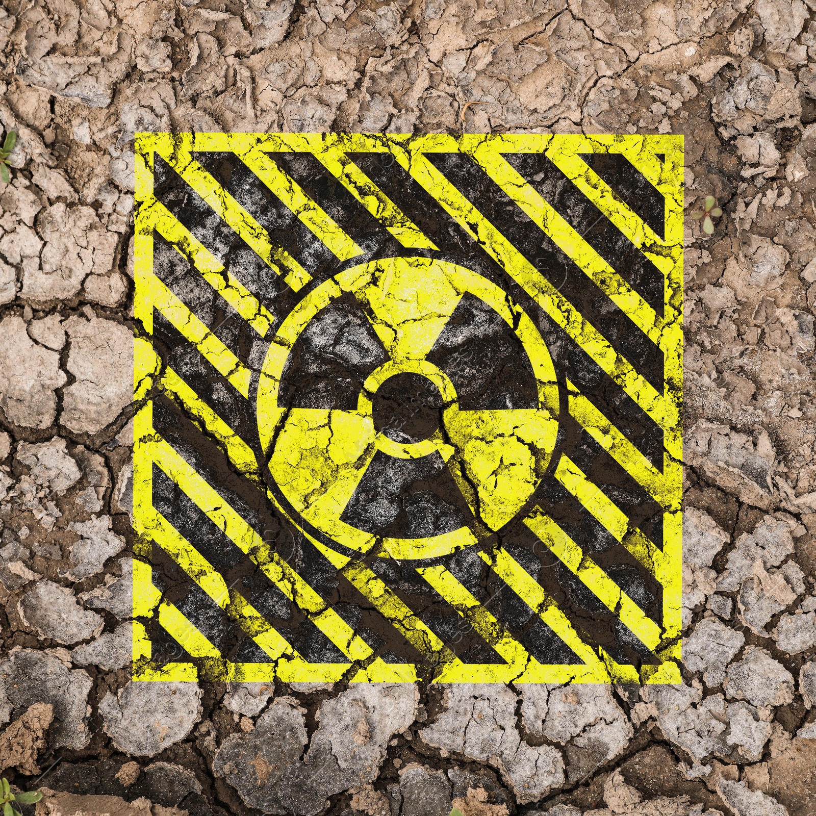 Yellow radioactive sign on cracked dry earth, top view. Radiological pollution Image of Yellow radioactive sign on cracked dry earth, top view. Radiological pollution