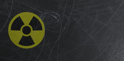 Image of Yellow radioactive sign on scratched black background, banner design. Radiological pollution
