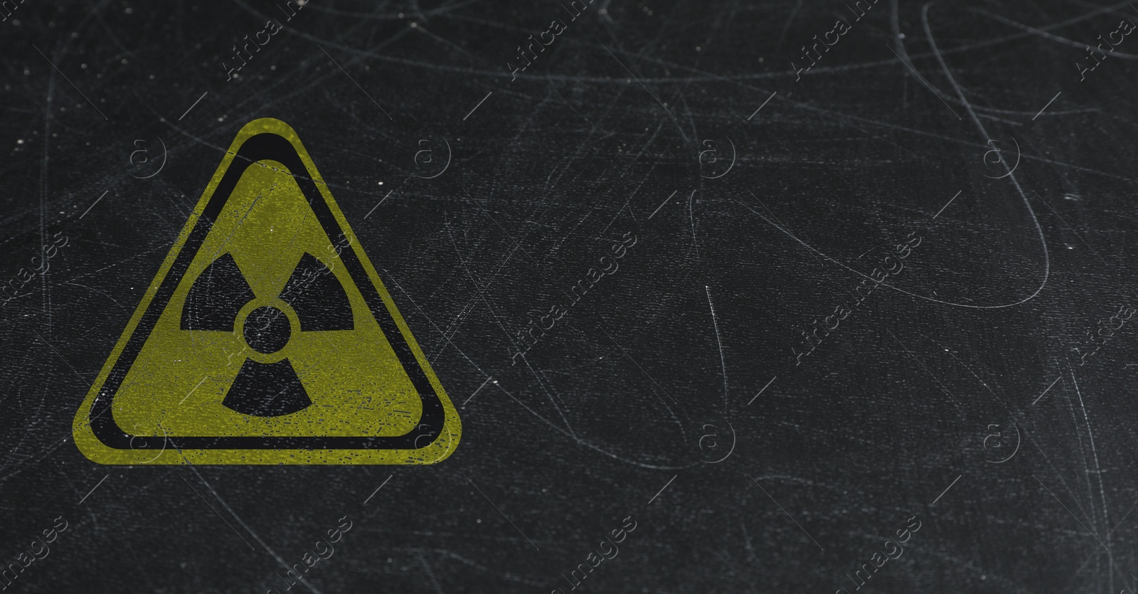 Image of Yellow radioactive sign on scratched black background, banner design. Radiological pollution