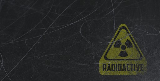 Image of Yellow radioactive sign on scratched black background, banner design. Radiological pollution