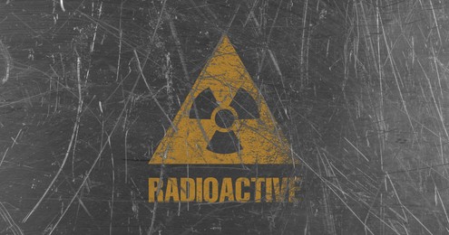 Image of Orange radioactive sign on scratched metal background, banner design. Radiological pollution