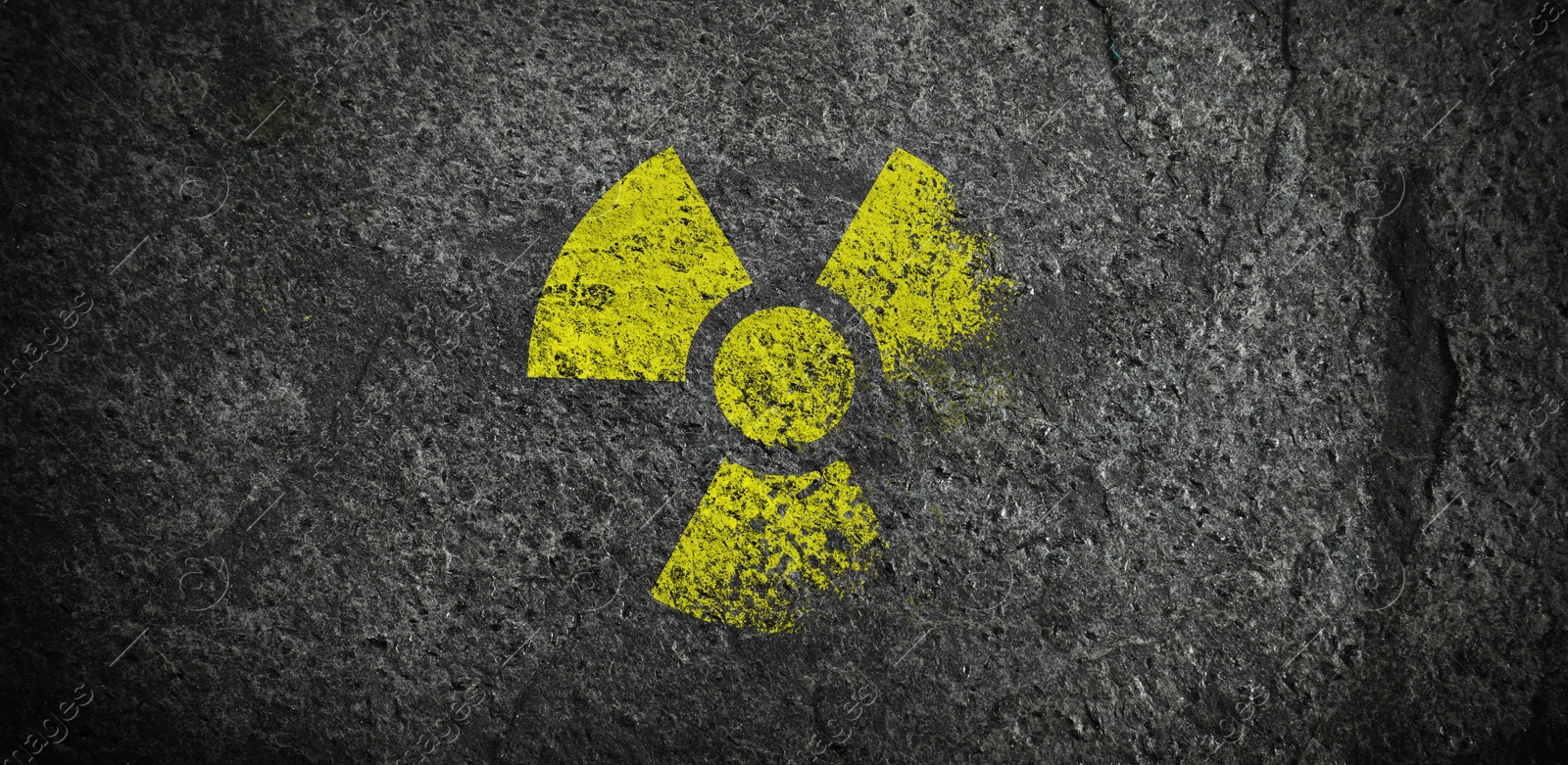 Yellow radioactive sign on dark stone background, banner design. Radiological pollution Image of Yellow radioactive sign on dark stone background, banner design. Radiological pollution