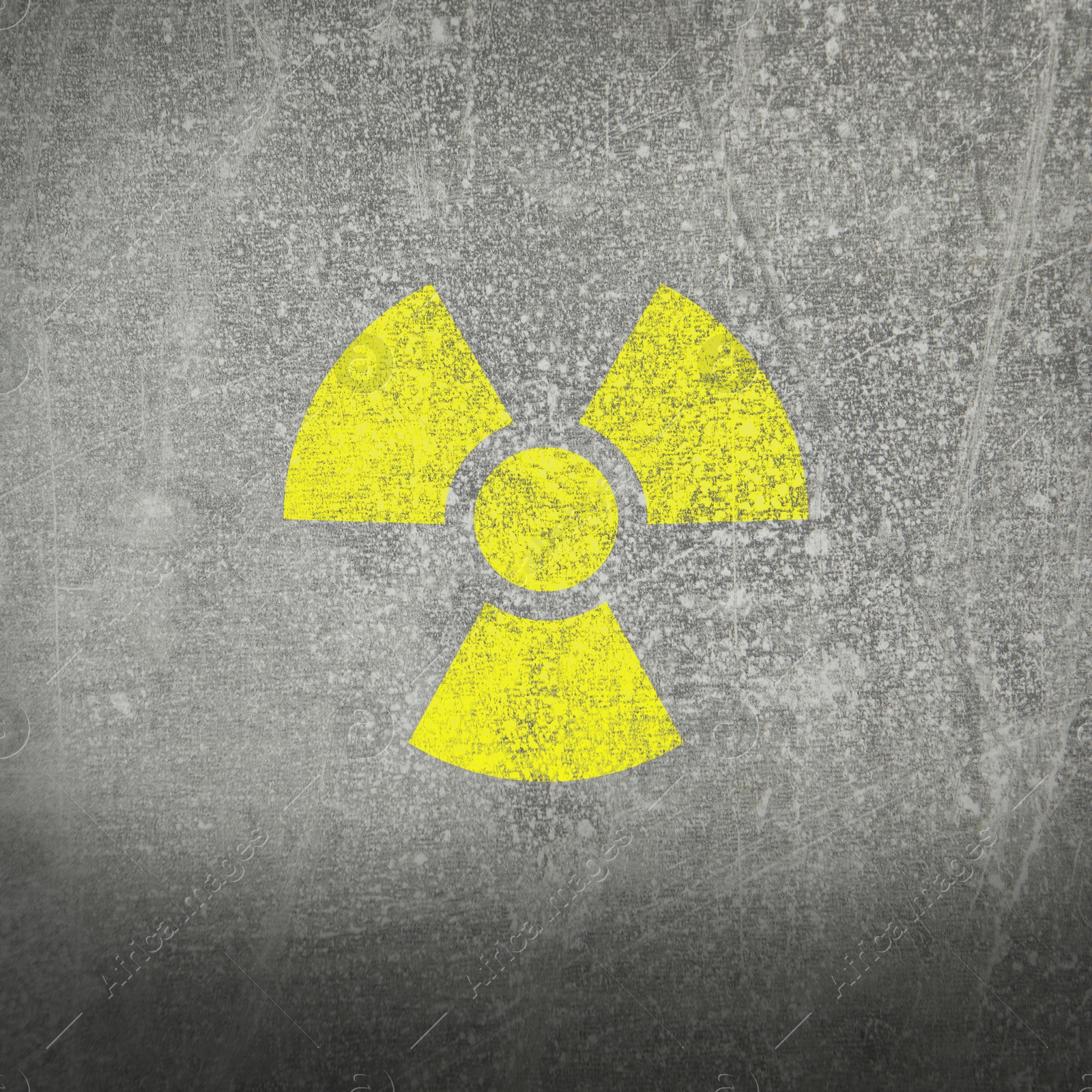 Image of Yellow radioactive sign on grey stone background. Radiological pollution