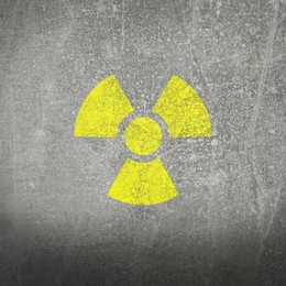 Image of Yellow radioactive sign on grey stone background. Radiological pollution