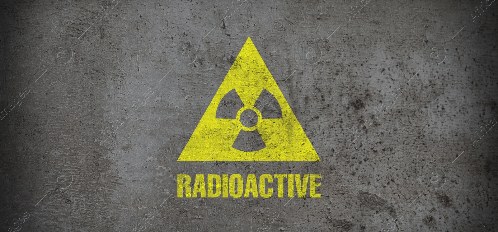 Image of Yellow radioactive sign on grey stone background, banner design. Radiological pollution