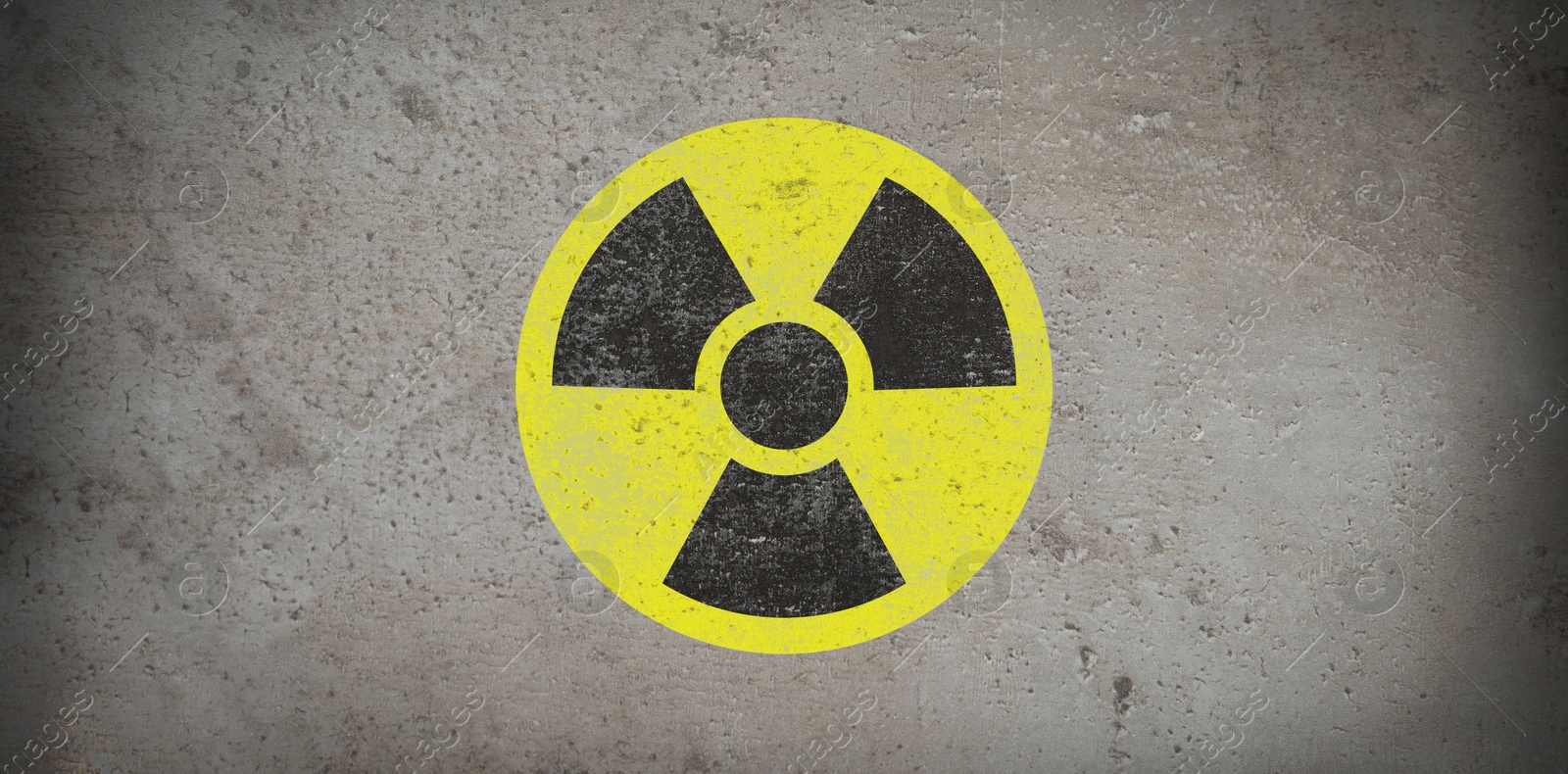 Image of Yellow radioactive sign on grey stone background, banner design. Radiological pollution