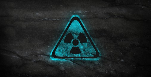Image of Cyan radioactive sign on black marble background, banner design. Radiological pollution
