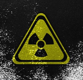 Image of Yellow radioactive sign on black textured background. Radiological pollution