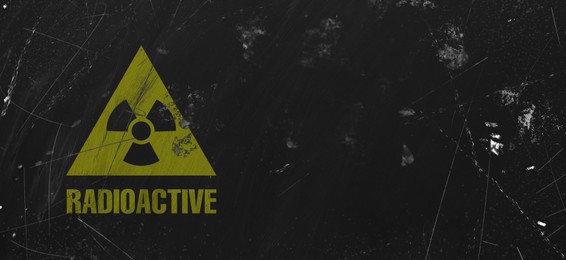 Image of Yellow radioactive sign on black textured background, banner design. Radiological pollution