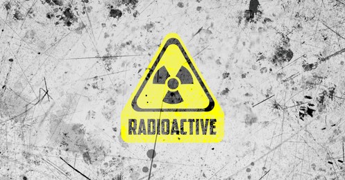 Image of Yellow radioactive sign on white textured background, banner design. Radiological pollution
