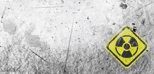 Image of Yellow radioactive sign on white textured background, banner design. Radiological pollution