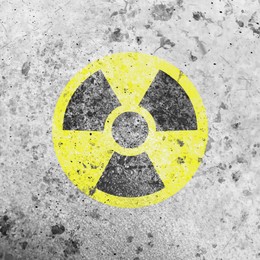 Image of Yellow radioactive sign on white textured background. Radiological pollution