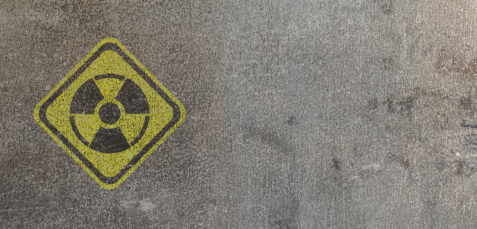 Image of Yellow radioactive sign on textured background, banner design. Radiological pollution