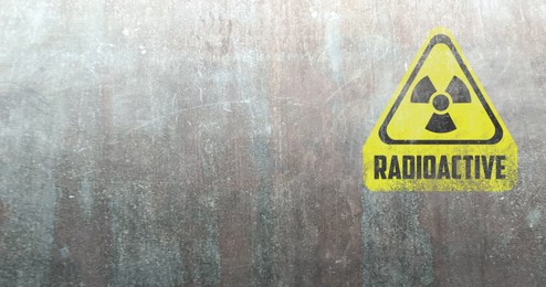 Image of Yellow radioactive sign on textured background, banner design. Radiological pollution