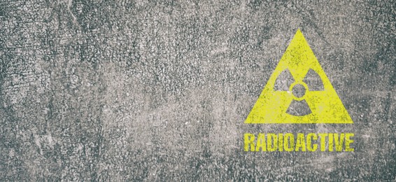 Image of Yellow radioactive sign on textured background, banner design. Radiological pollution