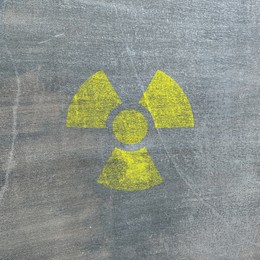 Image of Yellow radioactive sign on textured background. Radiological pollution