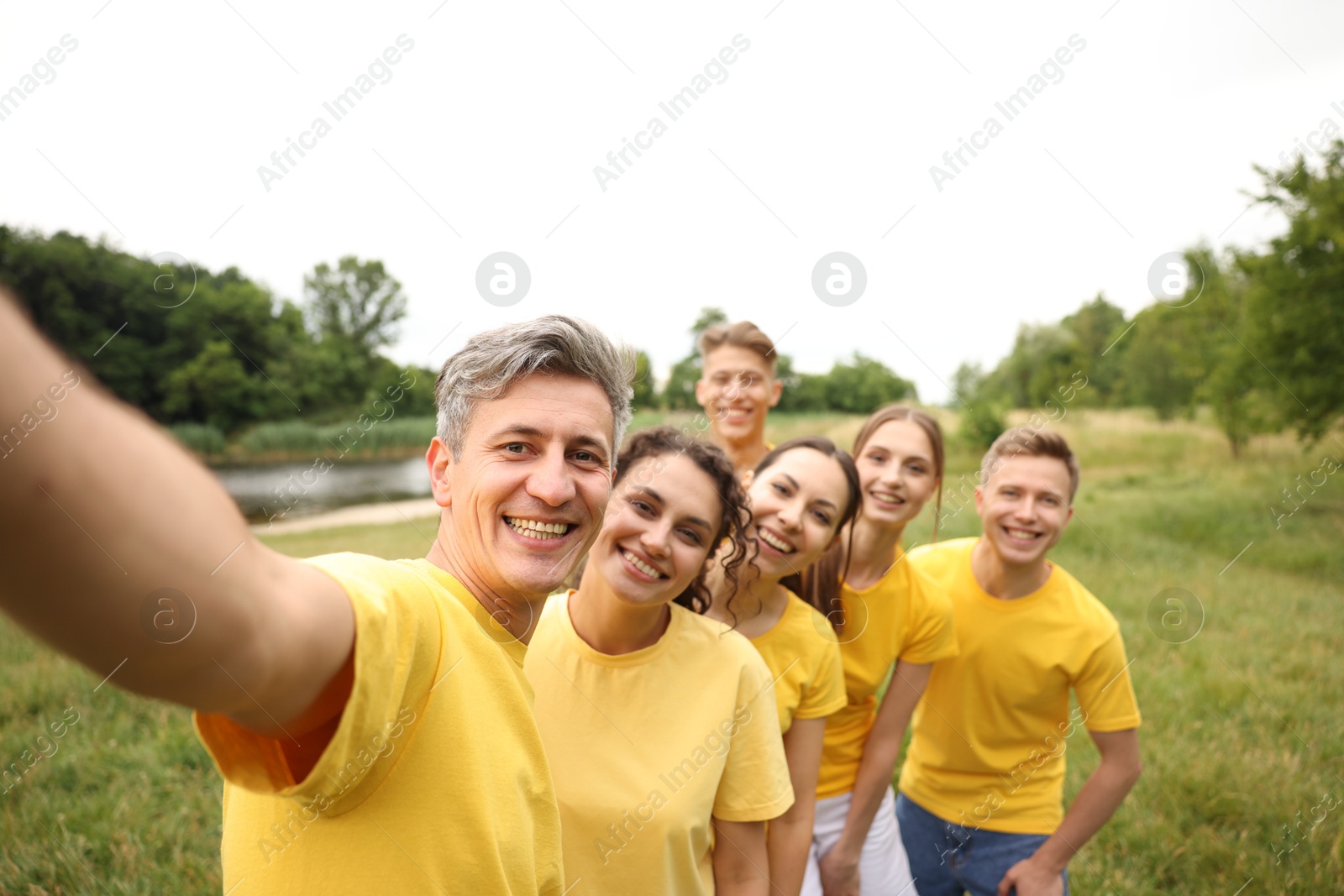 Team building. Group of happy people taking selfie outdoors Photo of Team building. Group of happy people taking selfie outdoors