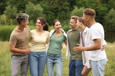 Photo of Team building. Group of happy people together outdoors