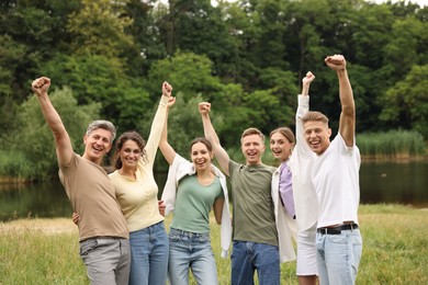 Photo of Team building. Group of happy people together outdoors