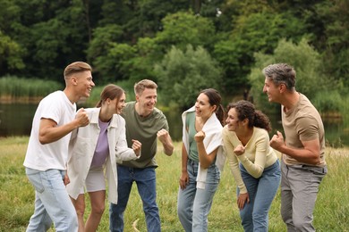 Photo of Team building. Group of happy people together outdoors