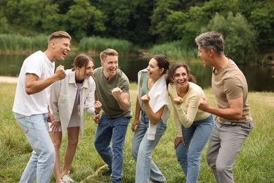Photo of Team building. Group of happy people together outdoors