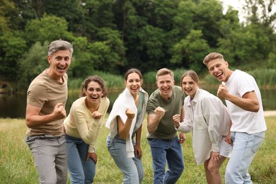 Photo of Team building. Group of happy people together outdoors