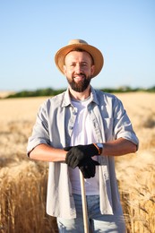 Photo of Farmer in field with ripe wheat outdoors