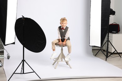 Photo of Little boy on white background in photo studio with professional equipment