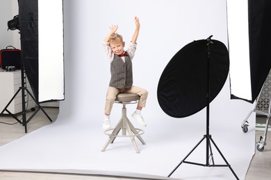Photo of Little boy on white background in photo studio with professional equipment