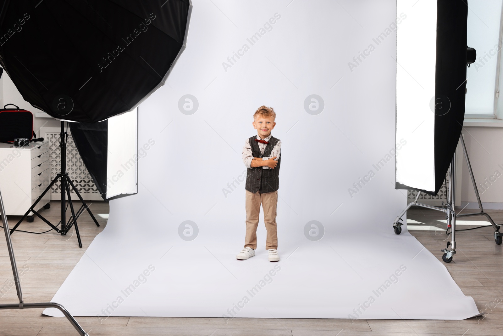 Photo of Little boy on white background in photo studio with professional equipment