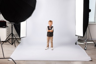 Photo of Little boy on white background in photo studio with professional equipment