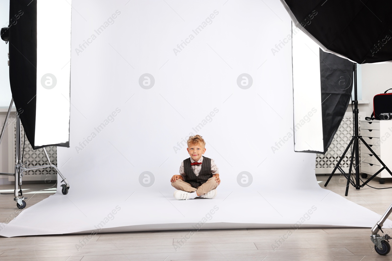 Photo of Little boy on white background in photo studio with professional equipment
