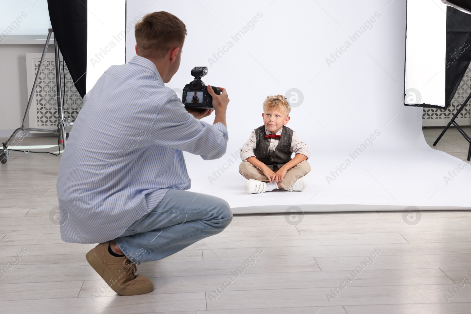 Photographer working with model in professional photo studio Photo of Photographer working with model in professional photo studio