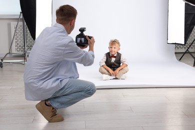 Photo of Photographer working with model in professional photo studio