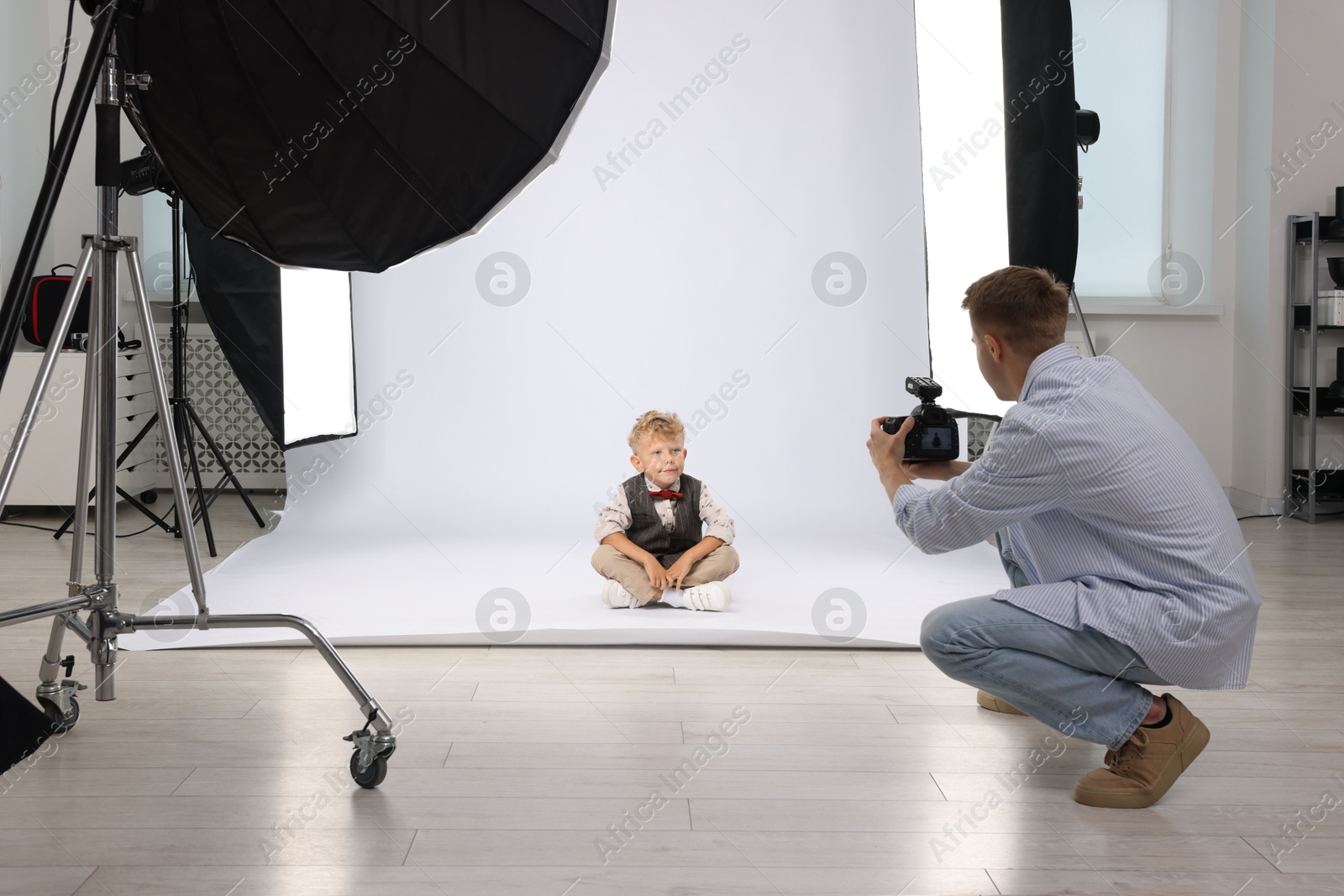 Photo of Photographer working with model in professional photo studio